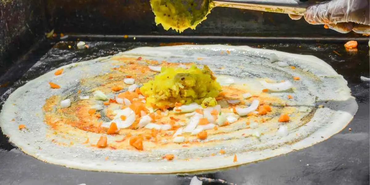 picture of Indian dosa being prepared on a hot stove