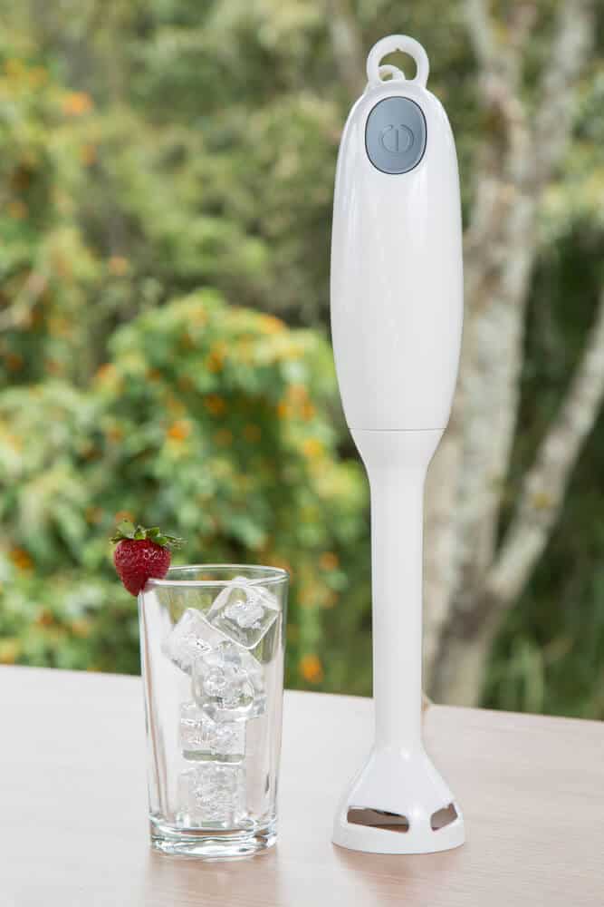 immersion blender to crush ice in a glass next to it